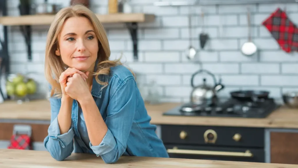 mature woman 50 kitchen relaxed confident smiling
Canva: woman over 50 kitchen calm peaceful confident.