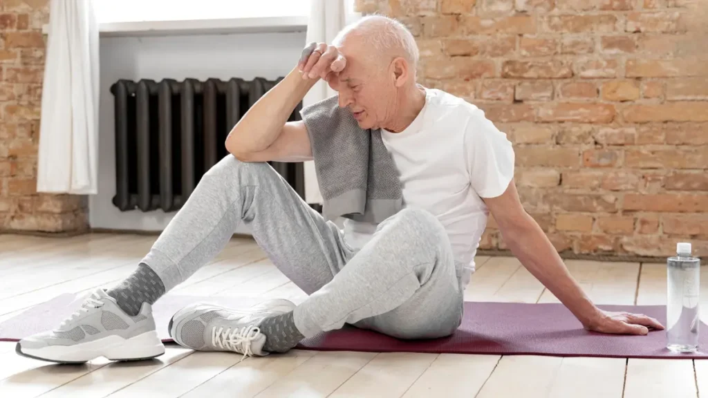 An older man resting on a yoga mat post-workout, illustrating how chronic inflammation silently slows muscle recovery in adults over 50.