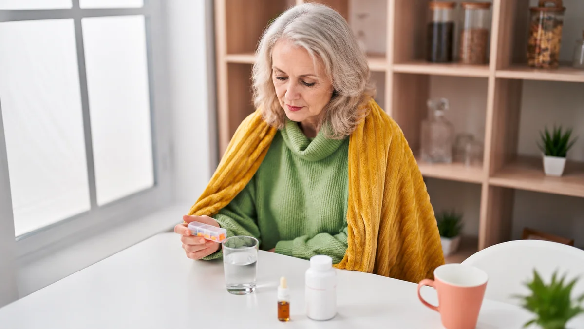 Mature woman evaluating her supplement routine to improve magnesium absorption for adults over 50.