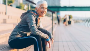 Mature woman taking a restful pause during her morning routine of walking after 50.