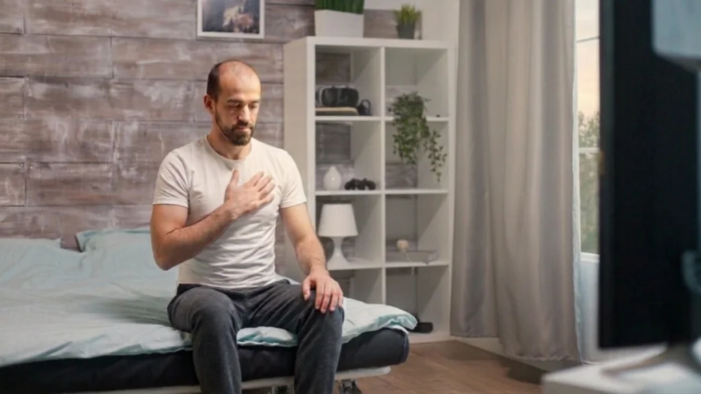 Man sitting on the edge of the bed each morning, pausing to notice a tiredness no algorithm captured.