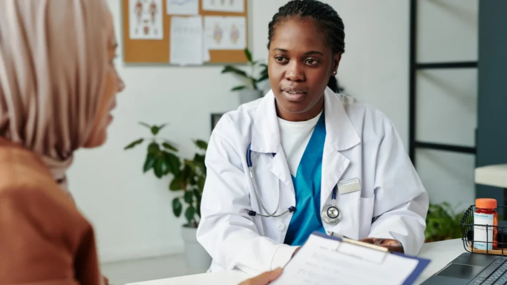Attentive doctor discussing prescription options with a patient to coordinate a safe medication review.