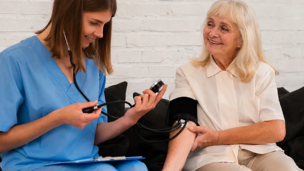 Woman in her 60s having her blood pressure checked by a nurse during a routine health visit.