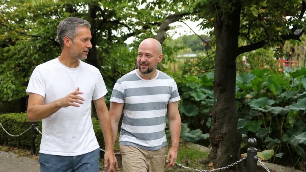 Two friends in their 60s walking briskly outdoors, a habit a strong sense of purpose makes easier to keep.