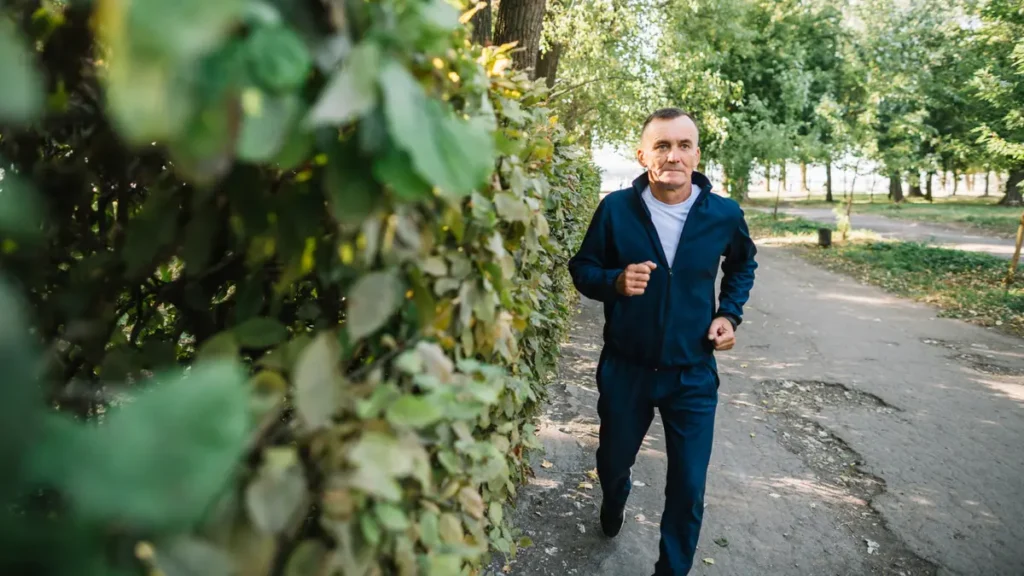 Man in his late 50s outdoors and engaged in activity, conveying renewed energy and motivation after treating the hormonal cause of low mood.